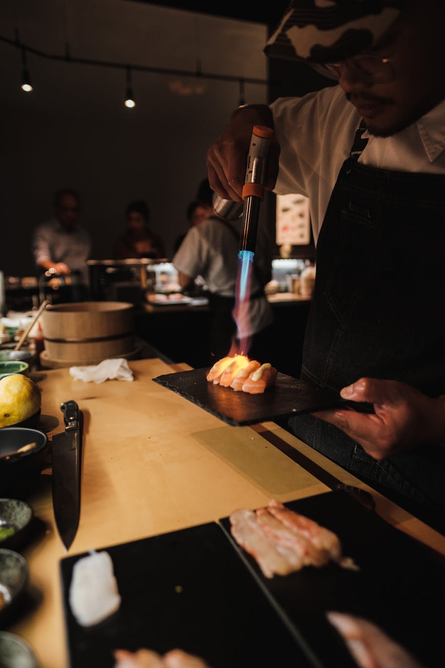 man preparing in a restaurant use camping gas canister torch